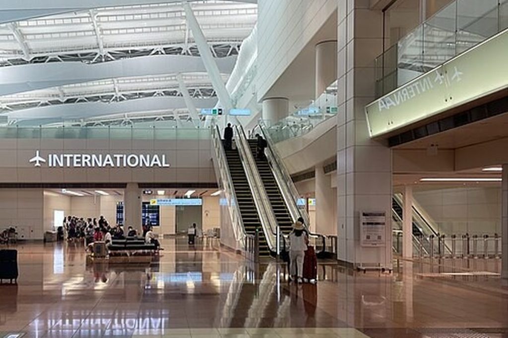 Spacious international section of Haneda Airport Terminal 2 with escalators and an INTERNATIONAL sign