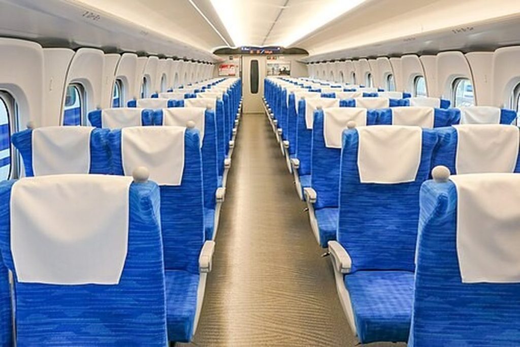 Rows of blue three-plus-two seats inside an N700S Tokaido Shinkansen ordinary car