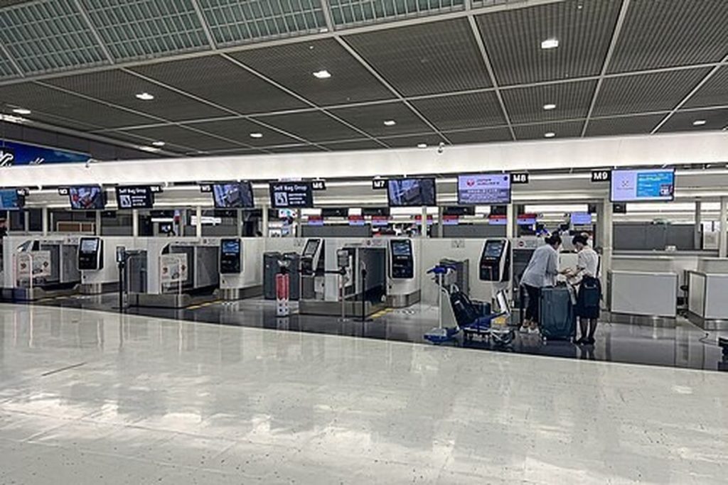 Long row of airline check-in counters in the departure hall of Narita Airport Terminal 2