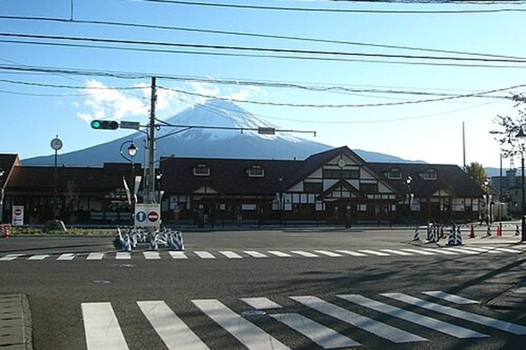 Kawaguchiko Station building with snow-capped Mount Fuji behind it