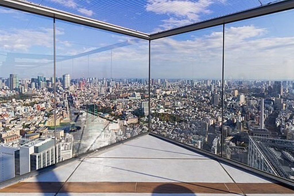 Open-air rooftop deck at Shibuya Sky with glass panels and a wide view over Tokyo