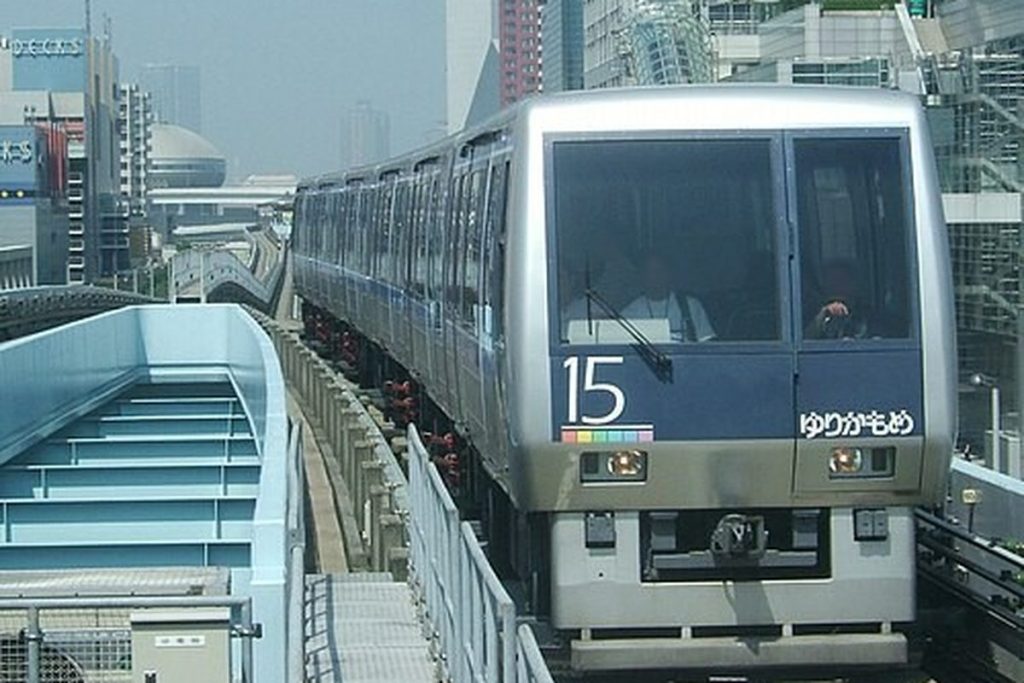 Driverless Yurikamome train arriving at an elevated station in Tokyo Bay